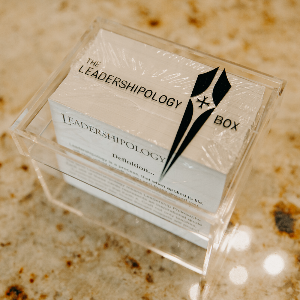 Clear plastic box showcasing 230 Leadershipology cards in a plastic wrapper, labeled 'The Leadershipology Box,' highlighting leadership quotes.